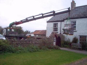 hiab lifting piano over wall | hiab hire wales